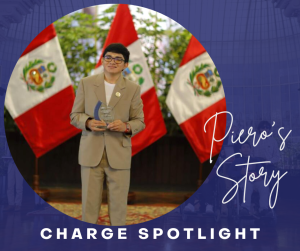 Young man in a suit stands in front of flags of Peru, holding an award.