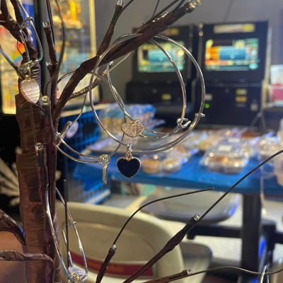 Blue CHARGE bracelets hang on a display