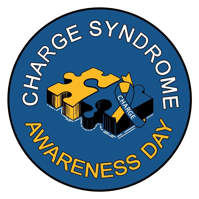 Yellow and Blue puzzle pieces fit together with a blue and yellow awareness ribbon