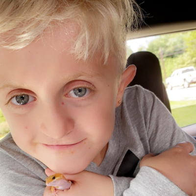 Young blond boy holding a yellow frog