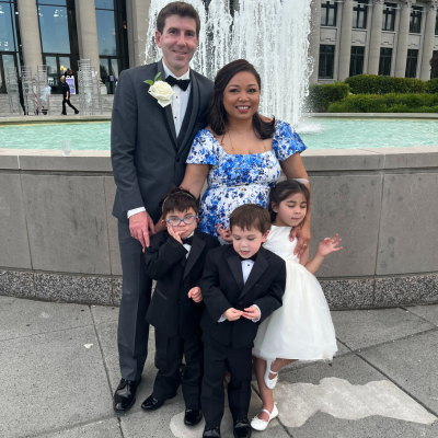 Family dressed for a fancy occasion with mom, dad, daughter and two sons, one of whom has CHARGE syndrome.