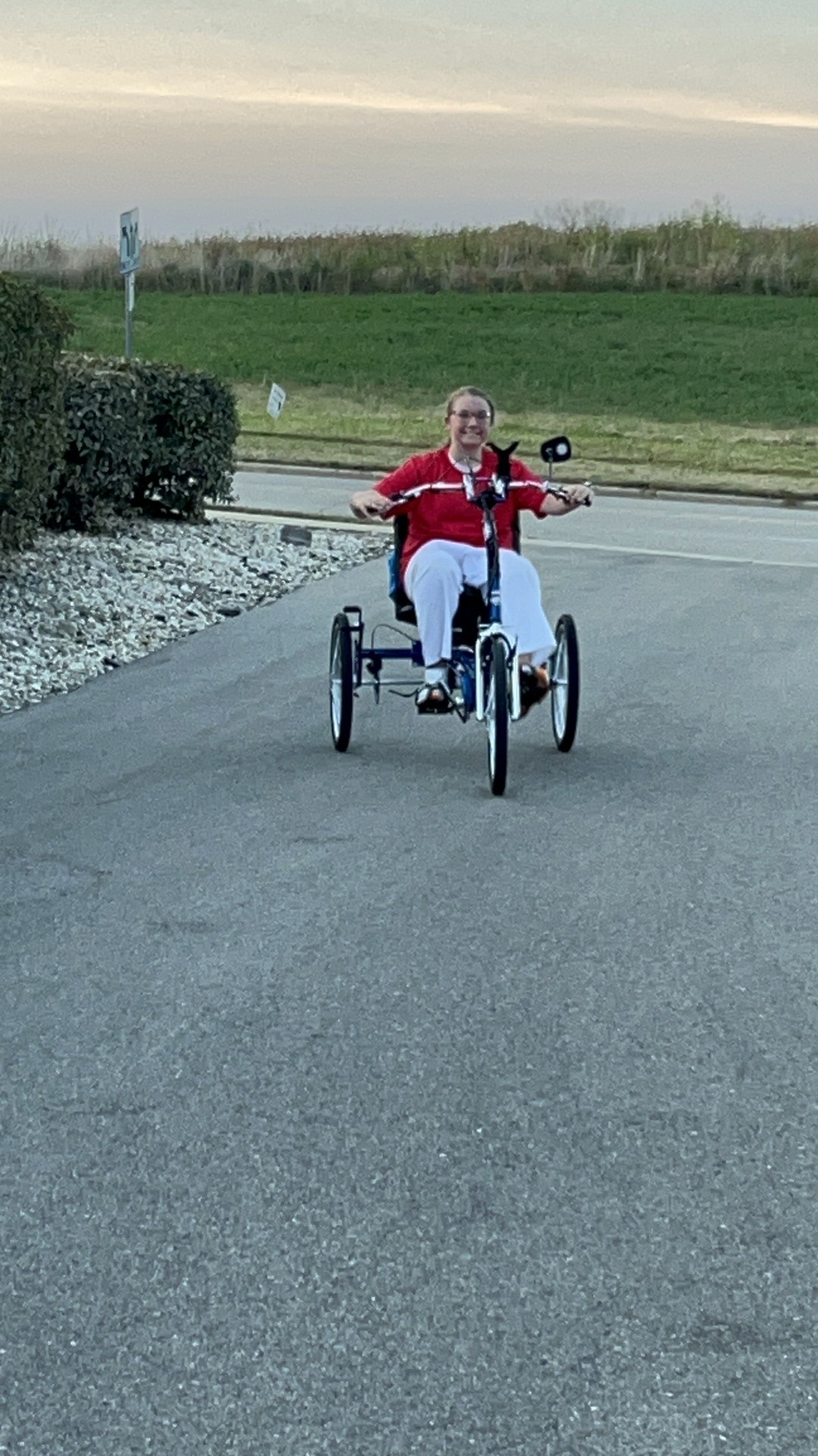 Teenage girl rides a 3-wheel adaptive bike