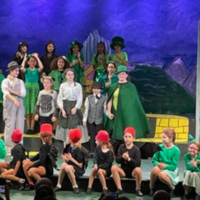 Young actors in costume on a stage. 