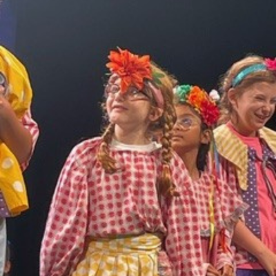 Young actors in costume on a stage. 
