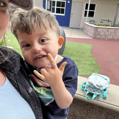 Toddler boy with CHARGE signs I love you