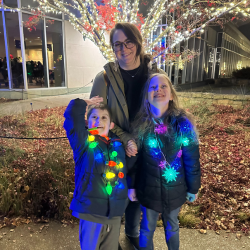 Mom and two kids, with christmas lights