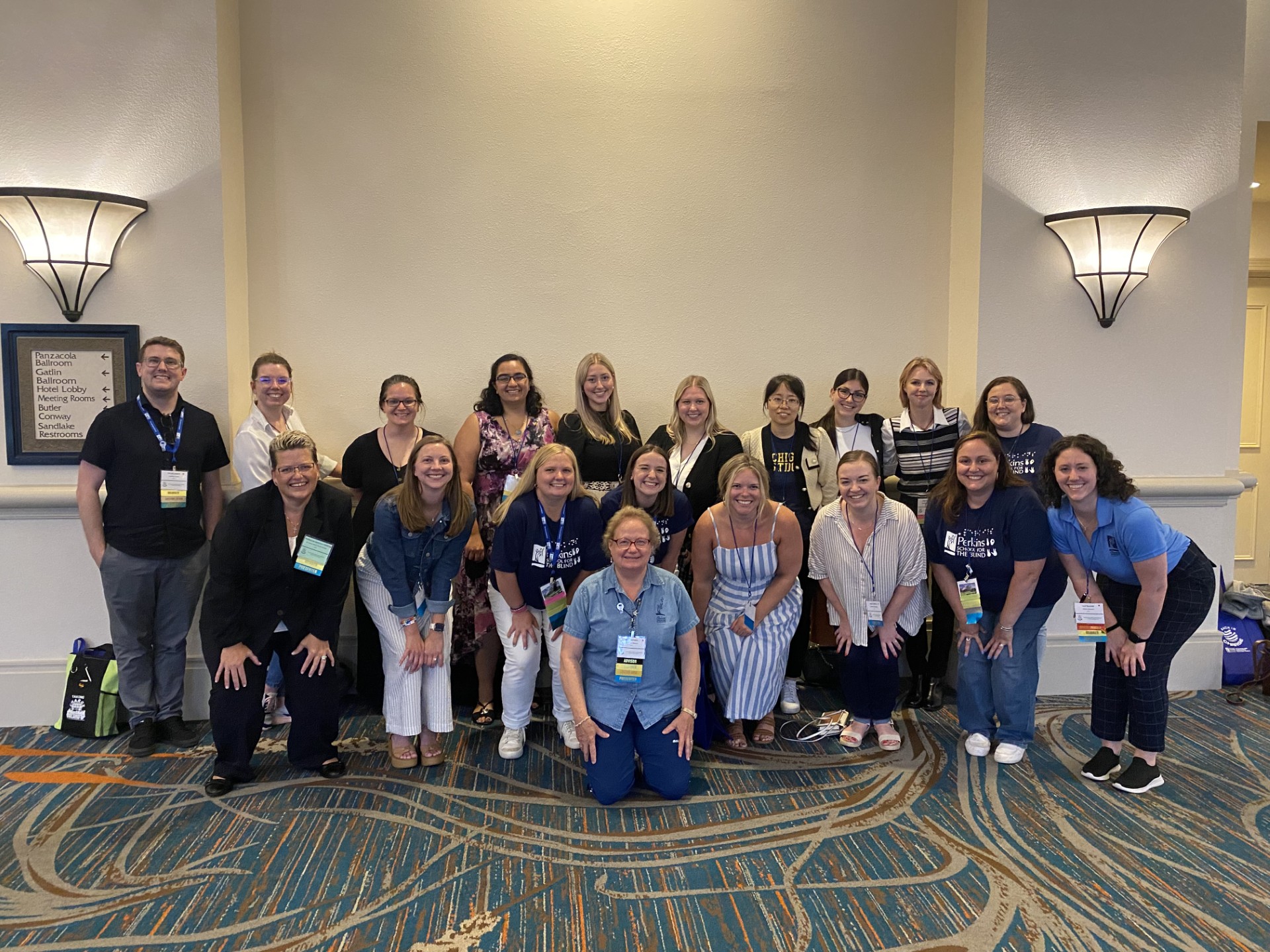 Meg Hefner poses surrounded by professionals at Conference